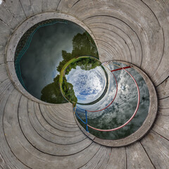 blue hole sphere or globe little planet inside grass or sand or dry ground frame background with...