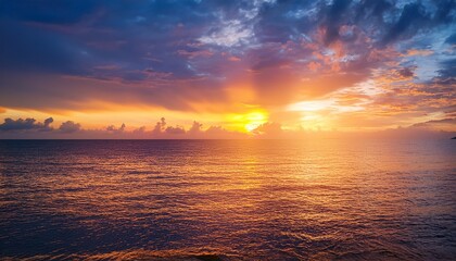 Obraz premium sunset sky clouds over sea in the evening with orange yellow sunlight on golden hour horizon sea sky landscape nature background summer sea sky