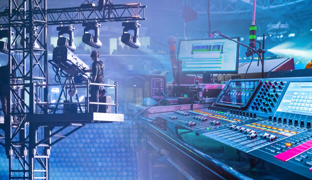 Concert or live event production with lighting rig, camera operator, sound mixing console, and control monitors, illustrating stage setup and broadcasting. – Event Production. Broadcasting.