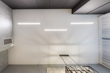 suspended ceiling with halogen spots lamps in form of squares and rectangles and drywall...