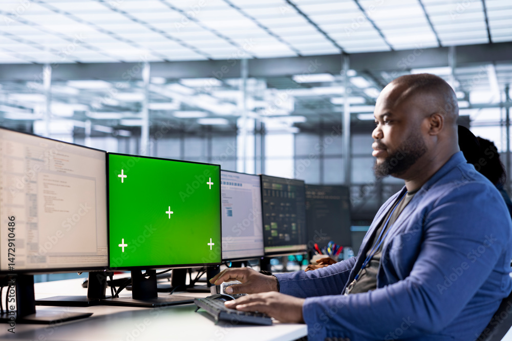Poster engineer in server hub using green screen computer to find firewall misconfigurations affecting perf