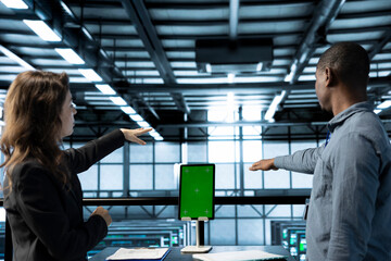 Computer scientists in data center use mockup tablet, inspecting server rigs, updating network...
