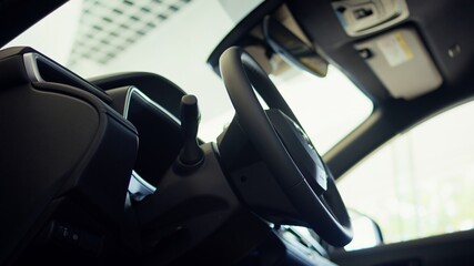 Close up shot of car interior console gear lever, wheel, beverage holder and transmission control...