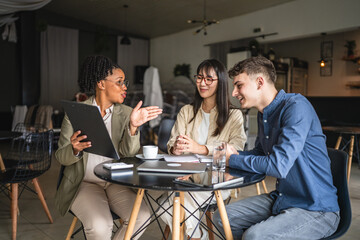 female financial adviser show finance plan to young entrepreneurs