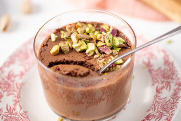 Close-up of chocolate mousse with pistachios and spoon
