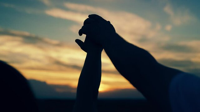 Man woman couple stretch their hands to sun. Adventures, travel. Prayer sunset, faith in God. Relationships between Man woman raise their hands to sunset sky. Teamwork trust. Group of friends teamwork
