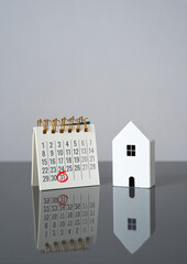 House and calendar with date marked. Last day of rent payment, tenants moving out. Deadline for...
