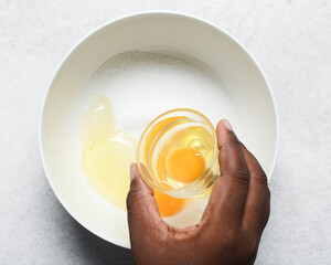 Overhead view of raw egg, whole raw egg in a glass bowl