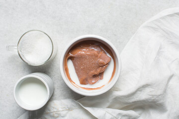 pap akamu or ogi in a white bowl, top view of nigerian guinea corn pudding in a white ramekin