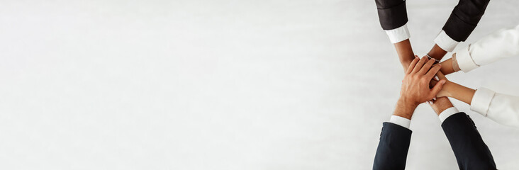 Successful partnership and teamwork. Corporate diverse business team stacking hands together, white...