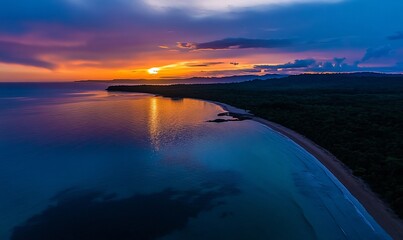 A captivating sunset illuminates the serene coastline with vibrant colors
