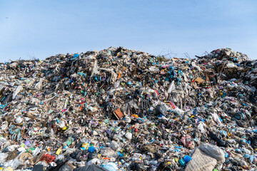 Overflowing Landfill Accumulation Against Blue Sky: Piles of Waste and Refuse Create Environmental Concerns for the Future
