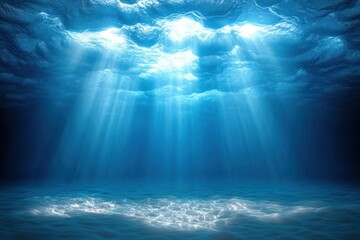 Sunlight beams penetrating through calm ocean water surface illuminating sandy seabed below creating a tranquil underwater scene