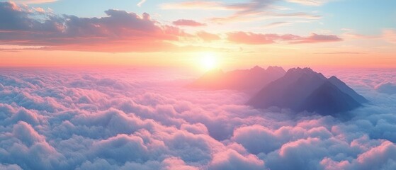 Sunset over mountain peaks rising above a sea of soft clouds with a colorful sky blending pink, orange, and blue hues creating a peaceful and majestic atmosphere