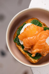 Eggs Benedict with Smoked Salmon and Spinach.
Classic Eggs Benedict served on toasted bread with poached egg, smoked salmon, sautéed spinach and creamy hollandaise sauce.