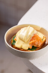 Eggs Benedict with Smoked Salmon and Spinach.
Classic Eggs Benedict served on toasted bread with poached egg, smoked salmon, sautéed spinach and creamy hollandaise sauce.