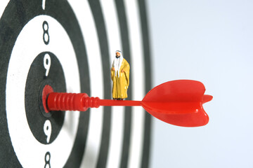 Miniature people toy figure photography. A Sultan wearing yellow bihst (king cloak) standing above...