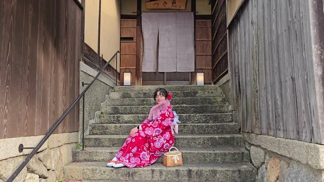 A pretty girl in a kimono. Kimono is the traditional dress worn popular in Japan. American girl posing in kimono outdoors. 