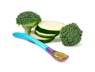 Baby food. Tasty puree in spoon, zucchini and broccoli isolated on white