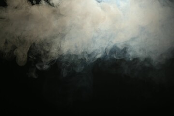 Beautiful smoke in lights on dark background