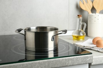 Cooking pot on cooktop indoors. Kitchen utensil