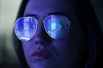 Stock exchange. Trader analyzing data, closeup. Graphs reflecting in her eyeglasses