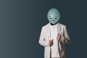 Balloon with sad face instead of man's head on dark grey background. Space for text