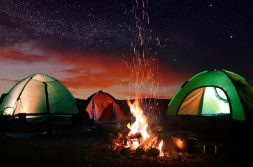 Fotobehang Bonfire near camping tents outdoors at night © New Africa