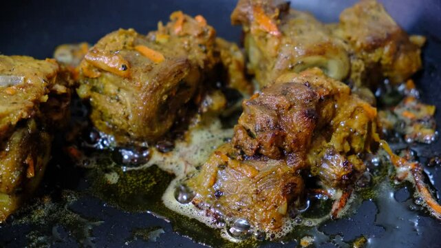 Braised ossobuco with vegetable sauce featuring carrots cooked in an iron pan.	