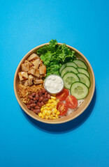 Meat and Veggie Bowl on Blue Background