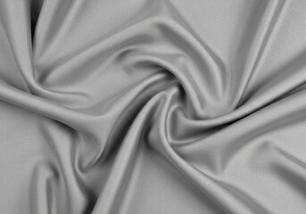 Fototapeta premium Grey fabric draped gracefully in soft folds.