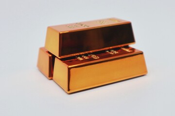 Stack of gold bars shining on a white background