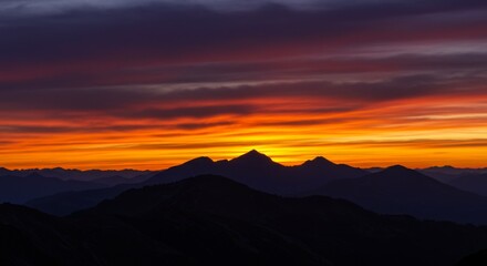 Vibrant Sunset Over Silhouetted Mountain Range