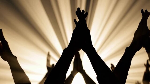 Silhouettes of raised hands reaching toward radiant golden light beams in the background. This powerful and energetic animation evokes themes of worship, celebration, unity, or revival &mdash; ideal for rel