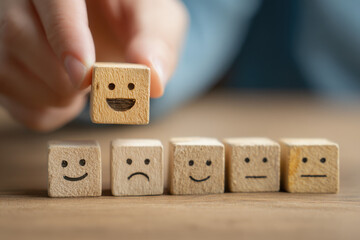 Hand placing a happy emoticon wooden cube above a row of mixed emotion cubes, symbolizing customer satisfaction and feedback. : Generative AI