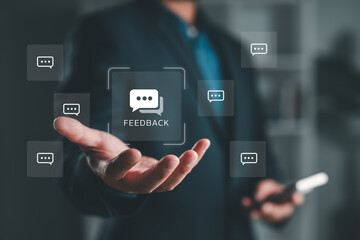 Businessman holding digital feedback icons, illustrating customer review, satisfaction, and communication concept in modern digital marketing and CRM strategies.