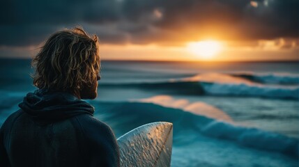 Fototapeta premium Surfer Contemplating Waves at Sunset in Quiet Ocean Scene