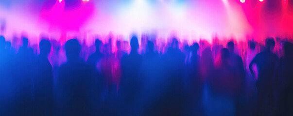 A blurry image of a crowd of people at a concert. The crowd is mostly blue and pink, with some red and white. Scene is energetic and lively, as the people are dancing and enjoying themselves