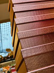 Elegant stacked boxes showcasing intricate texture highlight craftsmanship in a boutique setting during a vibrant daylight experience