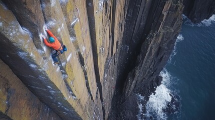 Climber ascends sheer rock face