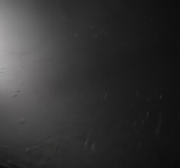 Deep black polished aluminum surface reflects light, showing subtle texture , industrial, texture