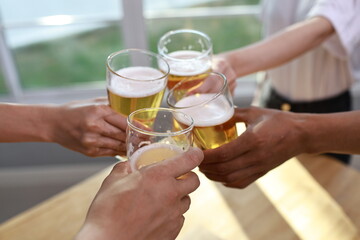 A joyful, multicultural group of friends and family gather outdoors at night, dancing, laughing, and enjoying music, wine, and warm conversation by the fire.