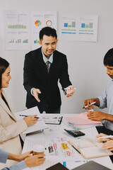 Team of financial advisory services. Asian advisor showing plan of investment to clients in the consultancy office..