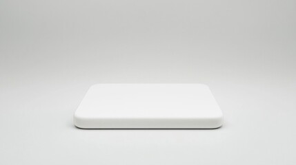 A minimalistic, white rectangular platform with rounded edges placed against a plain, light background.