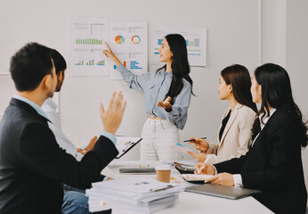Fototapeta premium Team of financial advisory services. Asian advisor showing plan of investment to clients in the consultancy office..