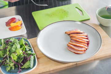 The chef serves roast duck. 