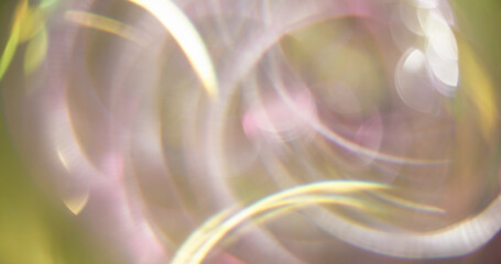 Twirling dazzle. Blurred radiance. Multicolored yellow pink circles lens flare on bokeh light...