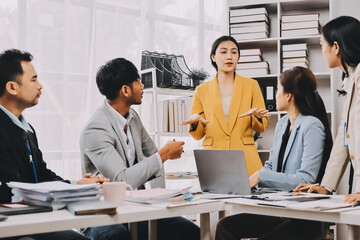 Team of financial advisory services. Asian advisor showing plan of investment to clients in the consultancy office..