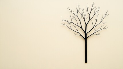Obraz premium Black Tree Silhouette on Beige Background Minimalist Design