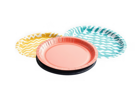 Stack of coral paper plates with yellow and teal patterned plates in the background, party supplies, isolated on transparent background